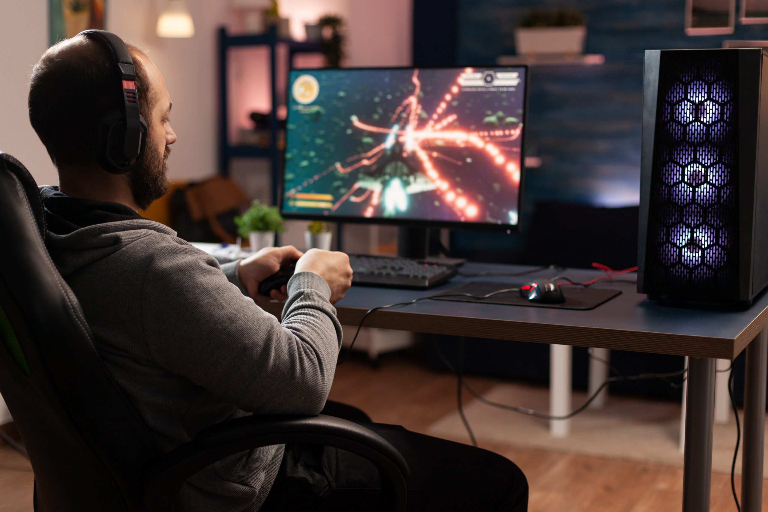 gamer-using-controller-play-online-video-games-computer-man-playing-game-with-joystick-headphones-front-monitor-player-having-gaming-equipment-doing-fun-activity-scaled.jpg