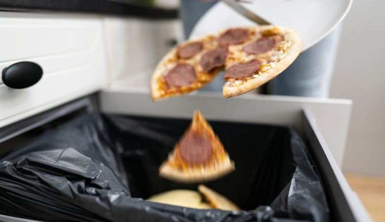 Food Waste. Throw Away Pizza In Dustbin