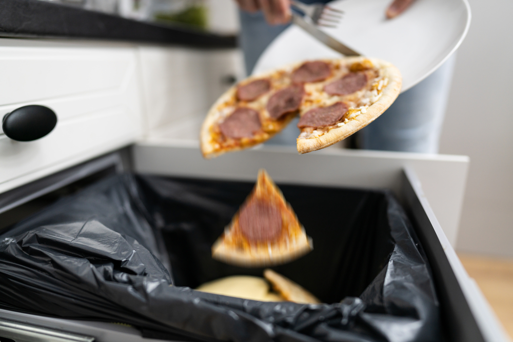 Food Waste. Throw Away Pizza In Dustbin